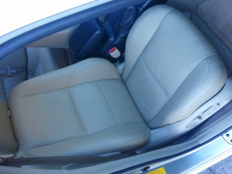 2008 Subaru Legacy - Interior view of tan leather front seats and center console.