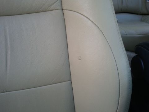 2008 Subaru Legacy - Interior view of beige leather seats, showing stitching detail and a small mark on the surface.