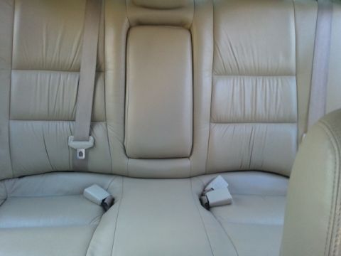 2008 Subaru Legacy - Interior view of the back seats of a car, showing beige leather upholstery and seatbelts.