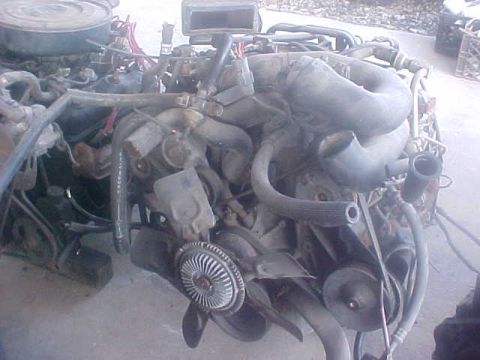 1996 Ford Bronco - Close-up view of a vehicle engine assembly, showing various components.
