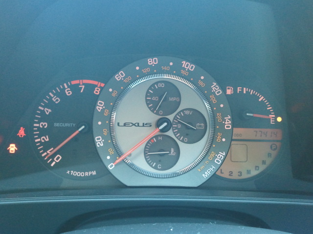 Lexus dashboard gauges showing speed, RPM, fuel, temperature, and odometer reading 77414