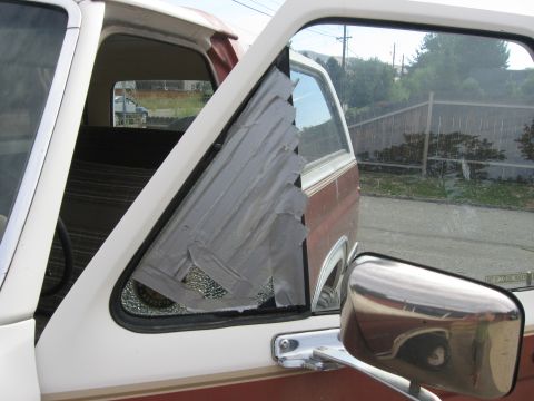 1981 Ford Bronco - The wing window of a 1981 Ford Bronco is covered in duct tape, obscuring the broken glass.