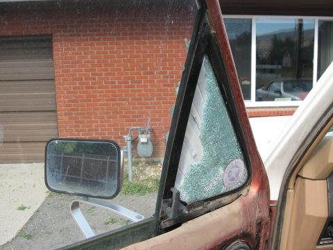 1981 Ford Bronco - The vent window glass is shattered, showing damage to the vehicle's interior.