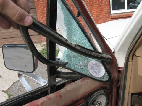 1981 Ford Bronco - Removing the rubber seal from a cracked vent window on a vehicle.