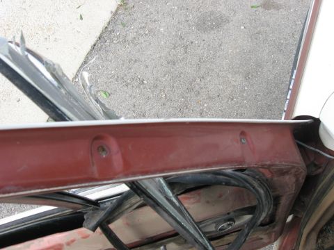 1981 Ford Bronco - Close-up of a car's interior door frame, showing the window assembly and trim.