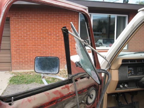 1981 Ford Bronco - Interior view of a 1981 Ford Bronco, highlighting the damaged door and dashboard components.