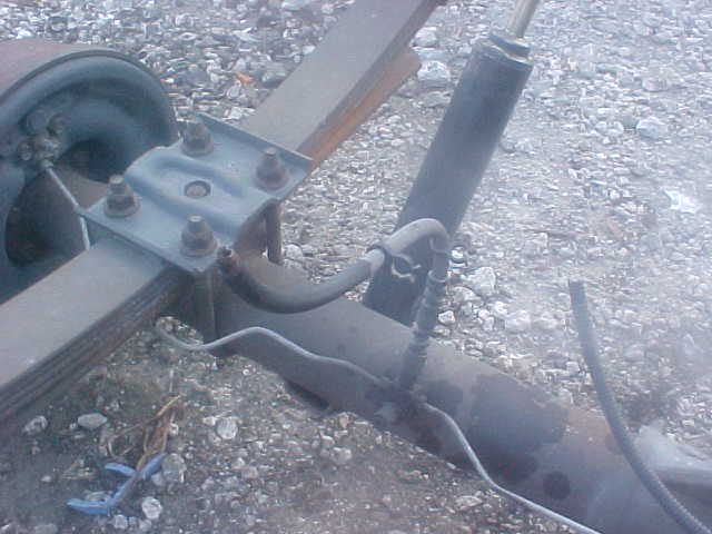 Rear axle with leaf springs and shock absorber. Supermotors.net logo visible