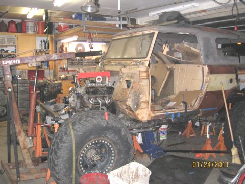 1961 International Scout 800 - A vintage SUV is undergoing an engine installation in a cluttered garage, with a date stamp of 01/24/2011.