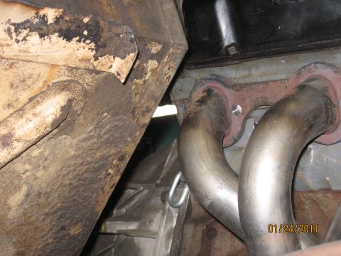 1961 International Scout 800 - The photo shows a close-up view of an exhaust manifold and part of the transmission system.