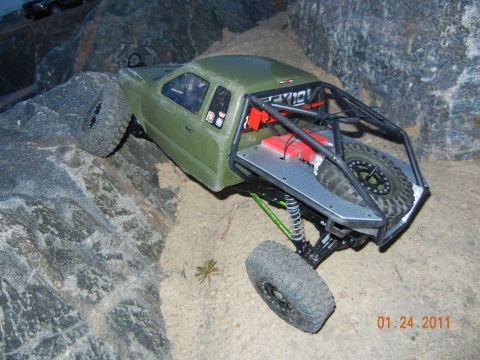 1996 Ford Bronco - RC rock crawler navigating a challenging rocky obstacle course.