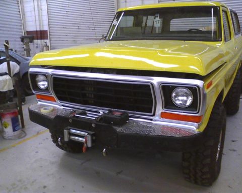 1978 Ford Bronco - Front view of a yellow 1978 Ford Bronco with a winch bumper and chrome grille.