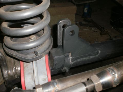 1995 Ford Bronco - Detail of a vehicle's suspension system, showing a coil spring and mounting hardware.