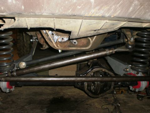 1995 Ford Bronco - Vehicle undercarriage with suspension and differential visible, likely undergoing modifications.