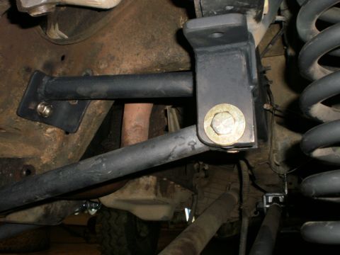 1995 Ford Bronco - Aftermarket suspension components are installed on the vehicle's frame, with a visible coil spring and sway bar link.