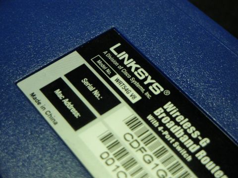1993 Ford Taurus - Close-up of a blue router's label showing product details and barcodes.