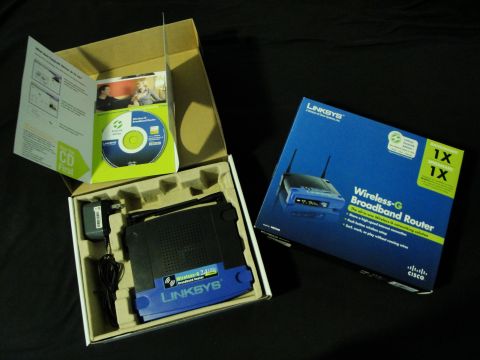 1993 Ford Taurus - Unboxed Linksys Wireless-G Broadband Router with accessories and its retail packaging.