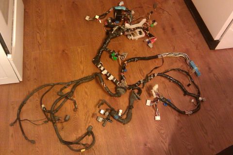 1997 Subaru Legacy - This is a complex automotive wiring harness, likely for an older vehicle, spread out on a wood floor.