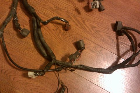 1997 Subaru Legacy - A collection of electrical wires and connectors laid out on a wooden floor.