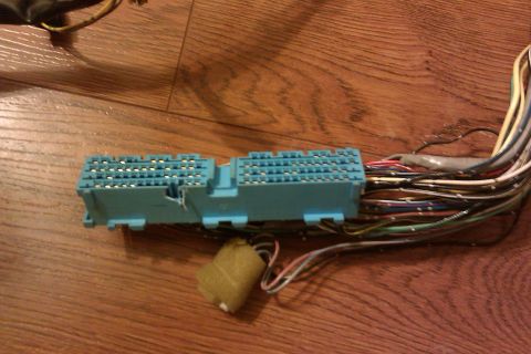 1997 Subaru Legacy - Close-up of a blue electrical connector and a wiring harness, likely from a vehicle's electrical system.