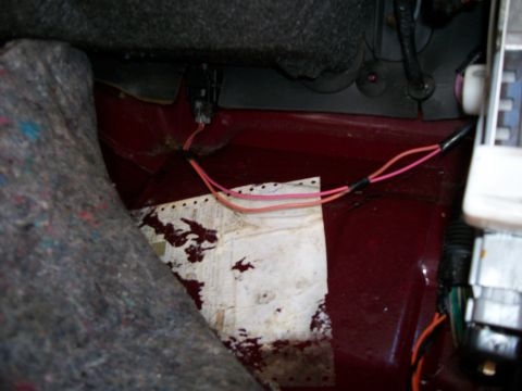 1990 Ford Bronco II - Close-up view of wiring and a floor panel inside a vehicle.