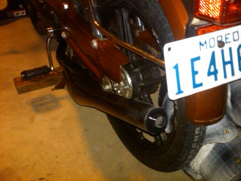 1981 Garelli Rally Sport - Close-up of a moped's rear section, showing the exhaust, wheel, and license plate.