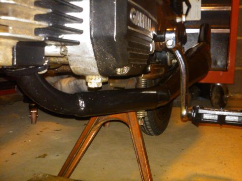 1981 Garelli Rally Sport - Close-up of a Garelli motorcycle engine and exhaust system on a stand.