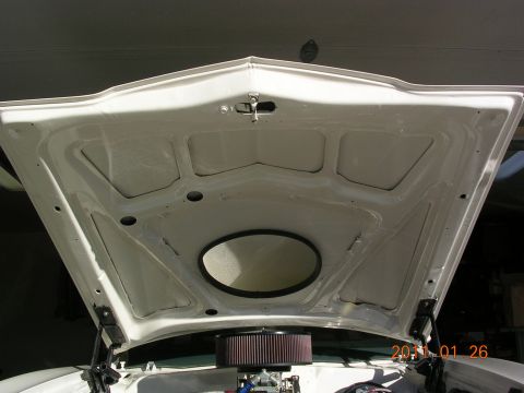1972 Ford Ranchero - The underside of a car's hood is shown, revealing the engine compartment and an air filter assembly.