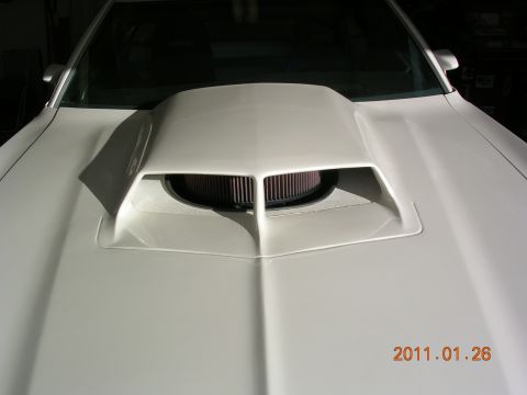 1972 Ford Ranchero - Close-up of a car's hood scoop with an exposed air filter, showing a date stamp.