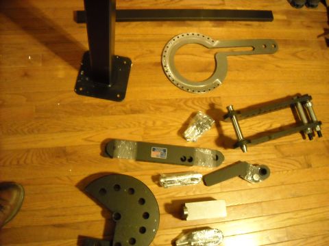 1979 Ford F-150 - Various metal tools and parts are spread across a wooden floor, suggesting a collection of mechanical equipment.
