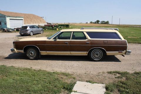 1978 Mercury Colony Park - A 1978 Mercury Colony Park station wagon is parked on a gravel lot with a modern SUV in the background.