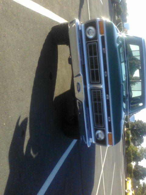 1988 Ford Bronco - Front view of a green 1977 Ford F-Series truck parked in a lot.