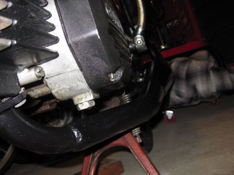 1981 Garelli Rally Sport - Close-up view of a motorcycle engine and exhaust system, with a person partially visible in the background.