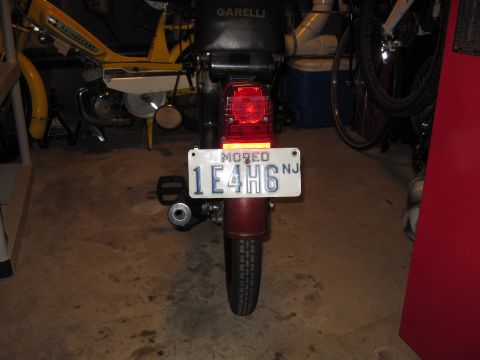 1981 Garelli Rally Sport - The rear of a moped is visible, showing its taillight and license plate.