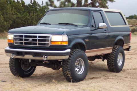 1995 Ford Bronco - This lifted 1995 Ford Bronco features a two-tone paint scheme and aggressive off-road tires.