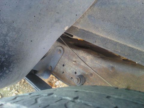 1993 Ford C-150 (Centurion Conversions) - Detail shot of a truck's undercarriage, showing the frame and a tire.