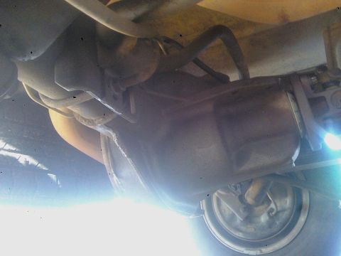1993 Ford C-150 (Centurion Conversions) - Underside view of vehicle's rear axle, differential, and exhaust system.