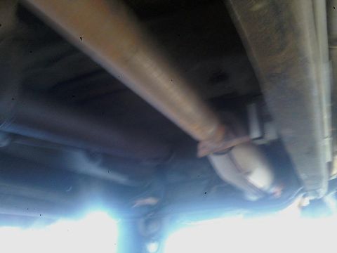 1993 Ford C-150 (Centurion Conversions) - The undercarriage of a vehicle, showing the exhaust system components.