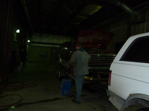 1993 Ford C-150 (Centurion Conversions) - Ford truck on trailer in garage, another vehicle parked nearby.