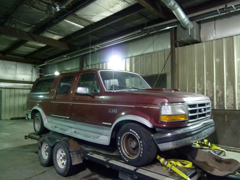 Maroon SUV with a hood scoop on a trailer. Grille indicates a 1992 model