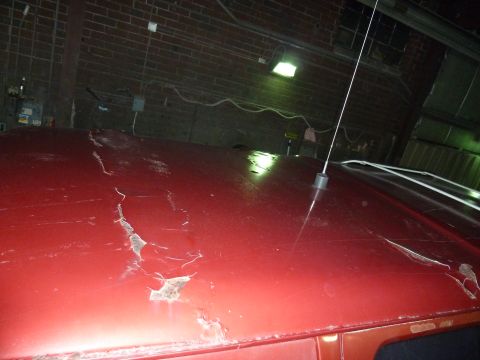 1993 Ford C-150 (Centurion Conversions) - The red paint on this vehicle's roof is severely cracked and peeling, revealing rust underneath. An antenna is visible on the roof.