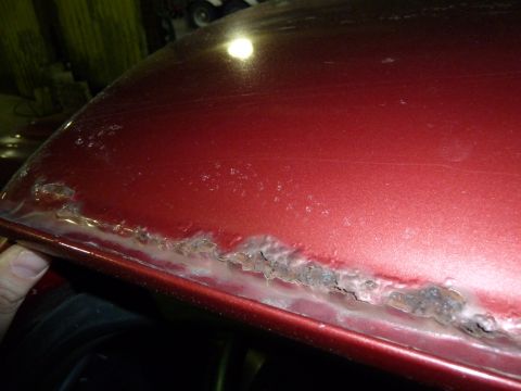 1993 Ford C-150 (Centurion Conversions) - Rust is eating away at the lower edge of this vehicle's body panel.