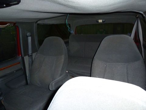 1993 Ford C-150 (Centurion Conversions) - Interior view of a van or large SUV with dark fabric seats and headliner.