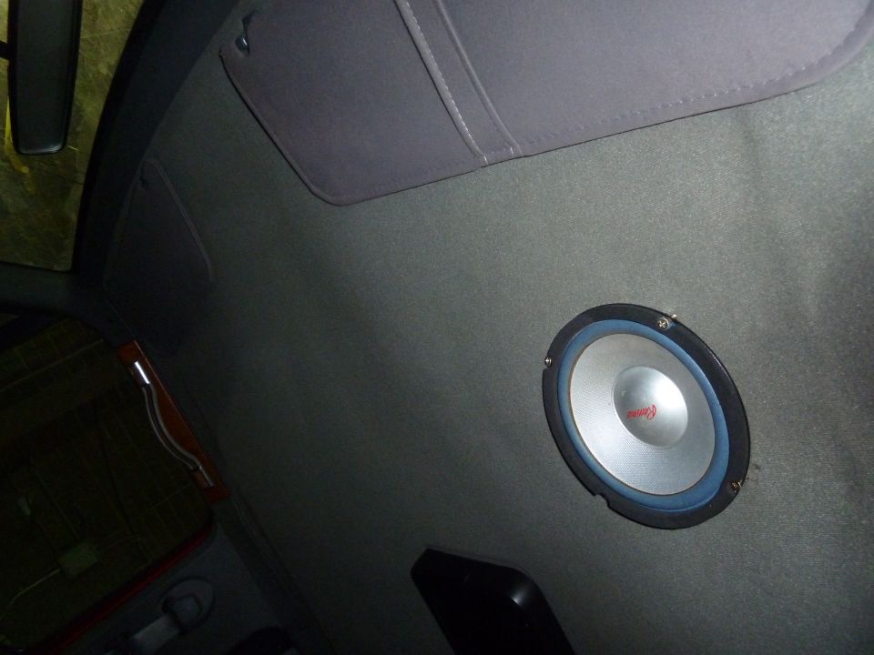 Speaker mounted in the headliner of a vehicle