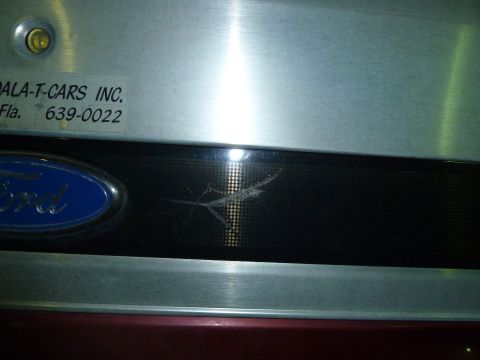 1993 Ford C-150 (Centurion Conversions) - A sticker with contact information is affixed to the vehicle's panel near the Ford emblem.
