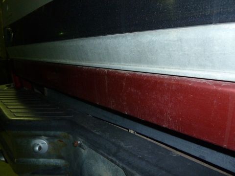 1993 Ford C-150 (Centurion Conversions) - Rear view of a truck's tailgate and bumper, showing wear and tear.
