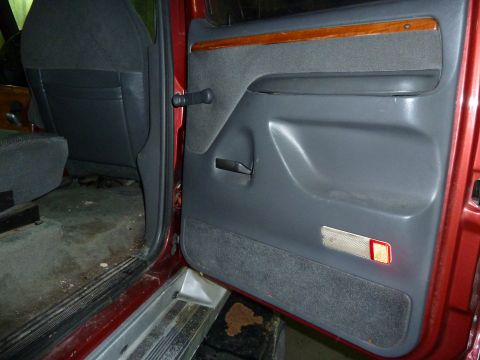 1993 Ford C-150 (Centurion Conversions) - Interior view of the driver's side door panel and seat in a 1993 Ford C-150 (Centurion Conversions).