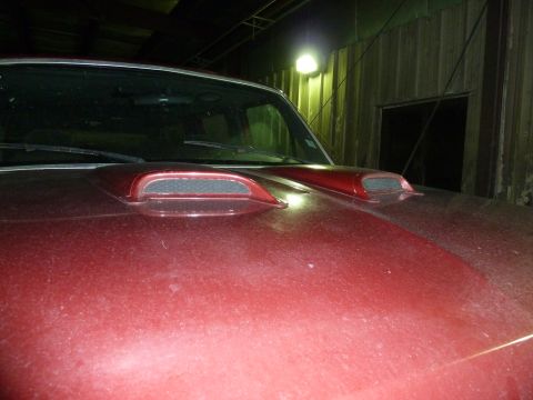 1993 Ford C-150 (Centurion Conversions) - Close-up of a red truck's hood two prominent air scoops.