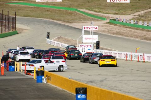 1995 Ford Taurus - Multiple vehicles are staged on a race track, with prominent Toyota branding visible.