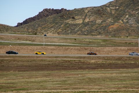 1995 Ford Taurus - A variety of vehicles travel along a highway with a mountainous backdrop.