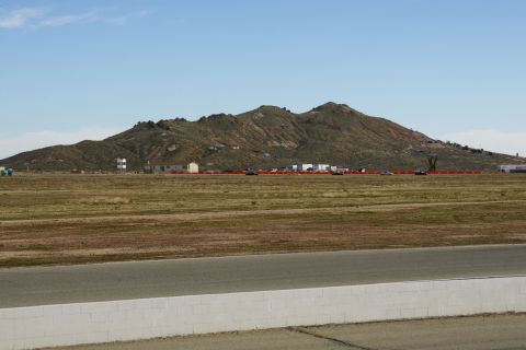 1995 Ford Taurus - A wide view of a race track with a mountain range in the background on a clear day.